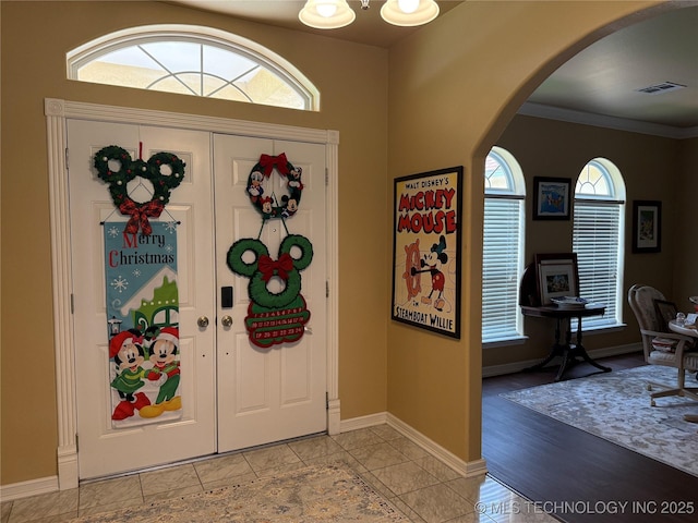 607 Nelson, Mcalester, OK 74501 - entrance foyer with arched walkways, plenty of natural light, and ornamental molding