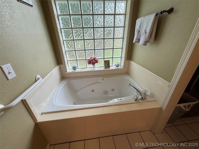 607 Nelson, Mcalester, OK 74501 - bathroom featuring a textured wall, a jetted tub, and tile patterned flooring