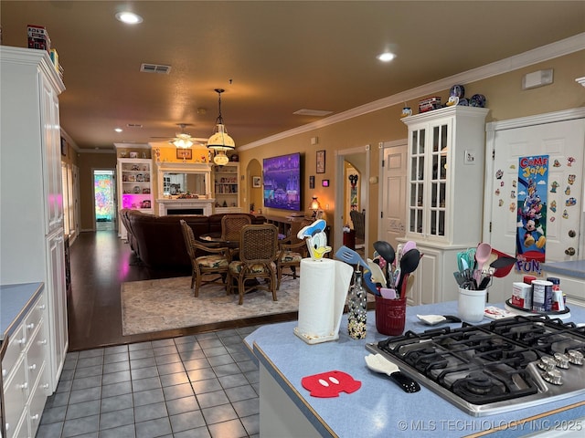 607 Nelson, Mcalester, OK 74501 - kitchen with stainless steel gas stovetop, ceiling fan, ornamental molding, light tile patterned floors, and open floor plan