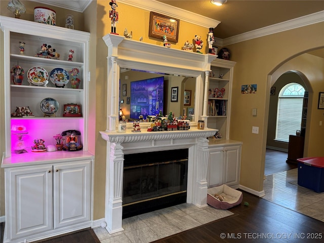 607 Nelson, Mcalester, OK 74501 - living room with arched walkways, crown molding, light wood-style floors, and a glass covered fireplace