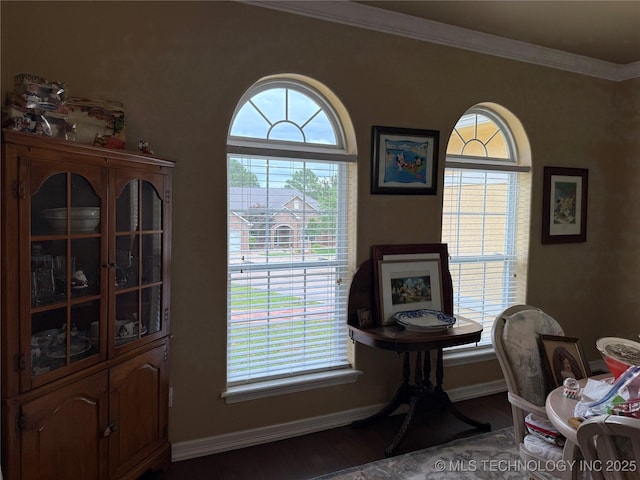 607 Nelson, Mcalester, OK 74501 - sitting room with wood finished floors, plenty of natural light, and crown molding