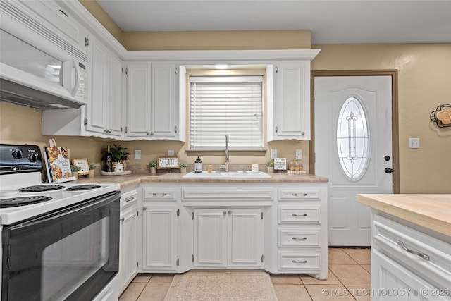 1604 9th Ave NW, Ardmore, OK 73401 - kitchen with white appliances, light tile patterned floors, white cabinets, and light countertops