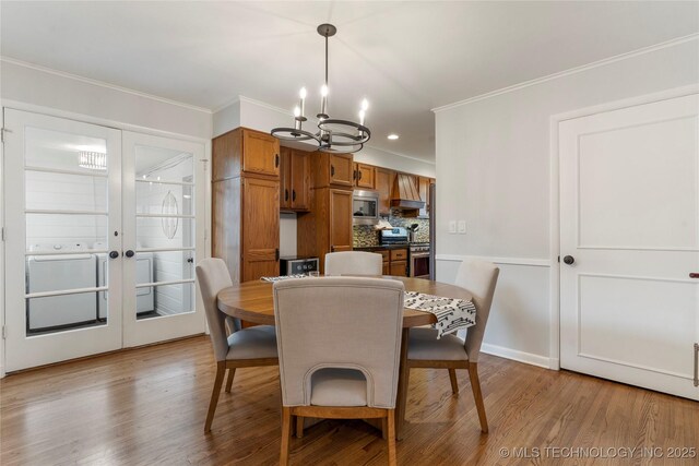 5914 E 26th St, Tulsa, OK 74114 - dining room featuring a chandelier, wood finished floors, ornamental molding, and recessed lighting