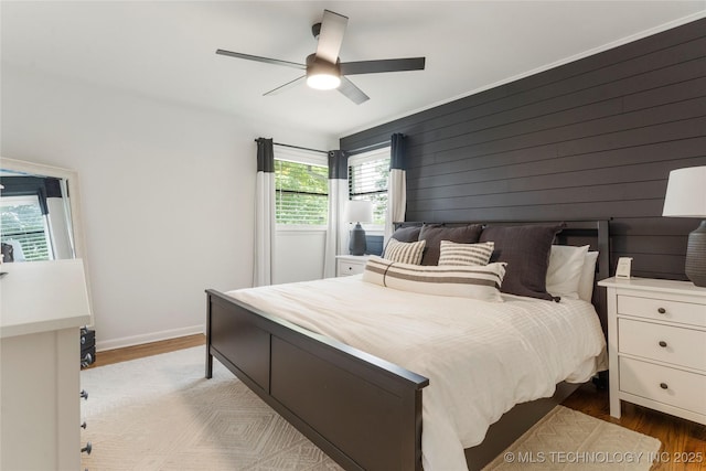 5914 E 26th St, Tulsa, OK 74114 - bedroom with wood finished floors, ceiling fan, and wooden walls