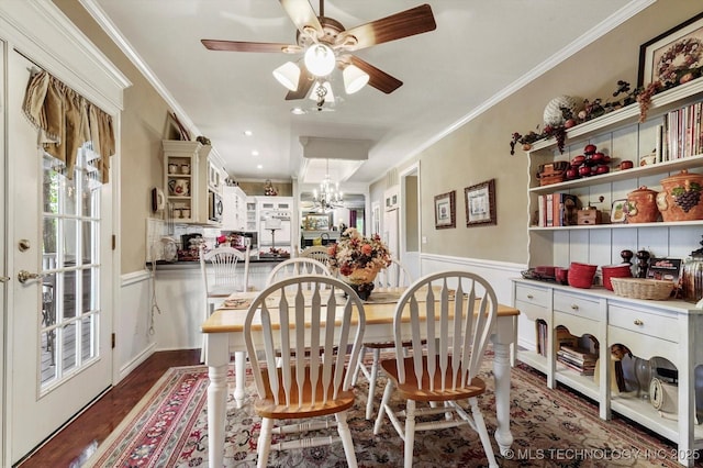 1110 N Renaissance Dr, Sand Springs, OK 74063 - dining space with wainscoting, dark wood-style floors, crown molding, ceiling fan, and a chandelier