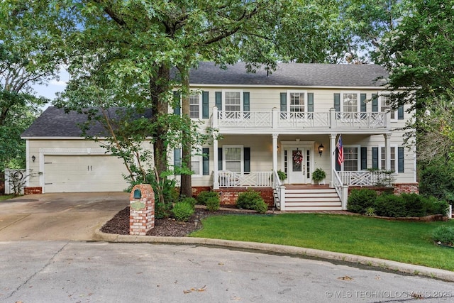1110 N Renaissance Dr, Sand Springs, OK 74063 - colonial inspired home featuring a porch, a balcony, an attached garage, driveway, and a front lawn