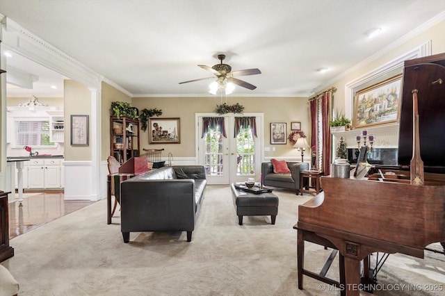 1110 N Renaissance Dr, Sand Springs, OK 74063 - living room with ceiling fan, ornamental molding, french doors, and light carpet