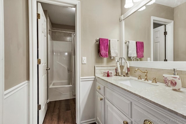 1110 N Renaissance Dr, Sand Springs, OK 74063 - bathroom with wood finished floors, vanity, shower / bathtub combination with curtain, and a wainscoted wall