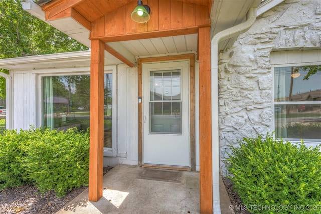 705 W Center St, Collinsville, OK 74021 - entrance to property featuring stone siding and board and batten siding