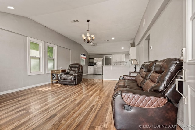 705 W Center St, Collinsville, OK 74021 - living area featuring lofted ceiling, light wood-style flooring, a chandelier, and recessed lighting