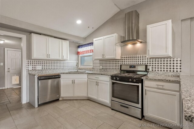 705 W Center St, Collinsville, OK 74021 - kitchen with stainless steel appliances, range hood, vaulted ceiling, backsplash, and white cabinets