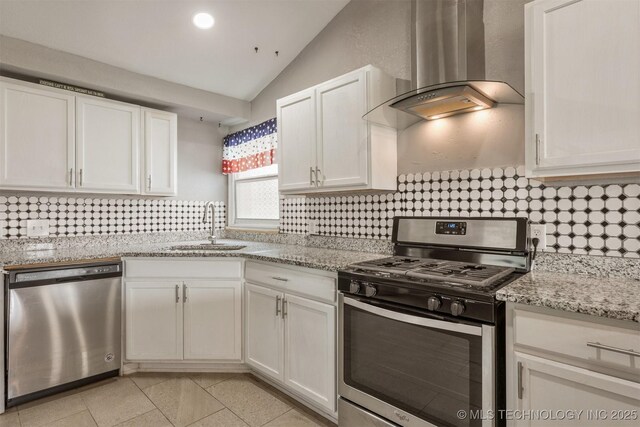 705 W Center St, Collinsville, OK 74021 - kitchen featuring stainless steel appliances, ventilation hood, vaulted ceiling, white cabinets, and tasteful backsplash