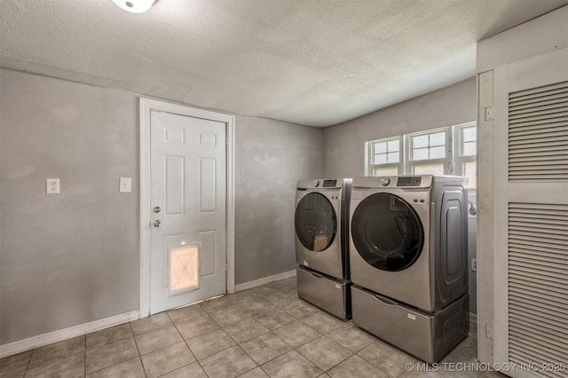 705 W Center St, Collinsville, OK 74021 - washroom featuring washer and dryer, a textured ceiling, and light tile patterned flooring