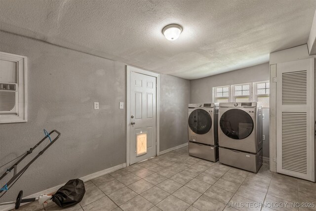 705 W Center St, Collinsville, OK 74021 - laundry area with washing machine and clothes dryer, a textured ceiling, light tile patterned floors, and a textured wall