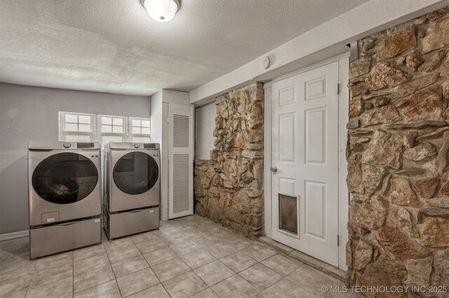 705 W Center St, Collinsville, OK 74021 - washroom with washer and dryer, a textured ceiling, and light tile patterned floors