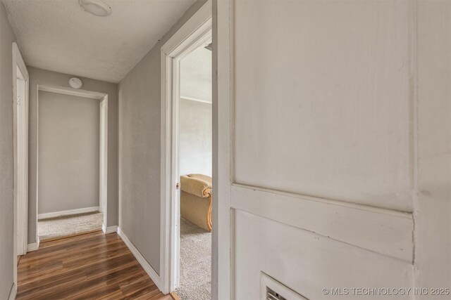 705 W Center St, Collinsville, OK 74021 - corridor with dark wood finished floors and baseboards