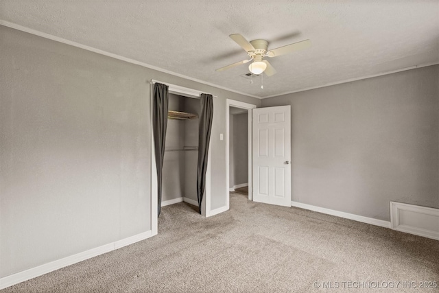 705 W Center St, Collinsville, OK 74021 - unfurnished bedroom featuring carpet floors, a closet, a textured ceiling, ornamental molding, and a ceiling fan