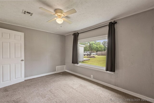 705 W Center St, Collinsville, OK 74021 - spare room with a ceiling fan, a textured ceiling, carpet floors, and crown molding