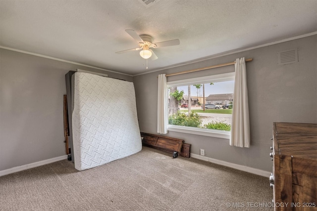 705 W Center St, Collinsville, OK 74021 - unfurnished bedroom featuring carpet flooring, crown molding, a textured ceiling, and ceiling fan