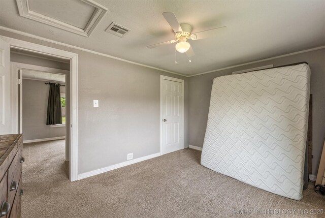 705 W Center St, Collinsville, OK 74021 - unfurnished bedroom with carpet flooring, attic access, crown molding, and ceiling fan
