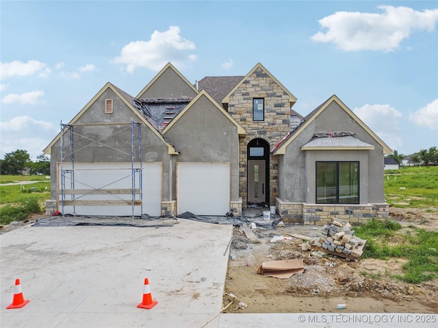 2614 E 134th Cir S, Bixby, OK 74008 - view of front of property with stone siding, a garage, stucco siding, and driveway
