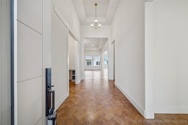 2614 E 134th Cir S, Bixby, OK 74008 - corridor with a tray ceiling and a chandelier