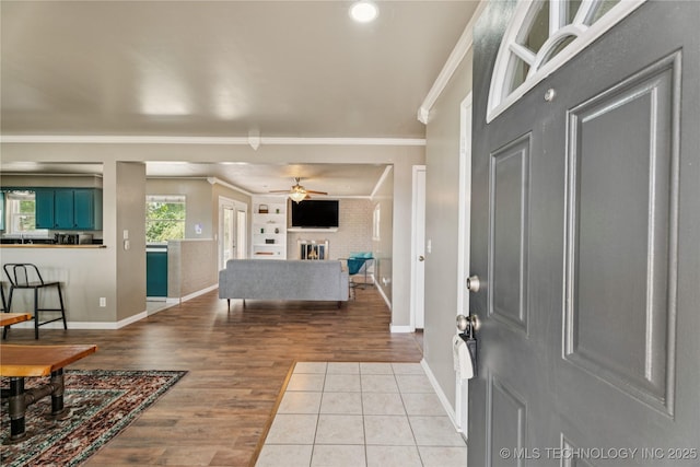 810 N 3rd St, Jenks, OK 74037 - foyer featuring ornamental molding, a ceiling fan, wood finished floors, a fireplace, and recessed lighting