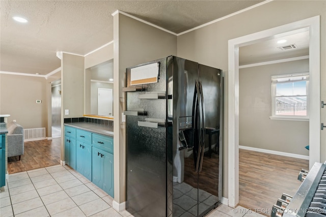 810 N 3rd St, Jenks, OK 74037 - kitchen with ornamental molding, blue cabinetry, black refrigerator with ice dispenser, light wood-style flooring, and recessed lighting