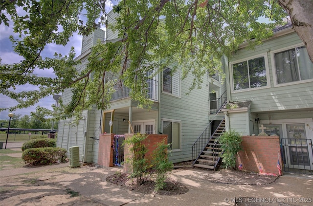 1730 E 67th St Unit K102, Tulsa, OK 74136 - view of front of house featuring a chimney and stairway