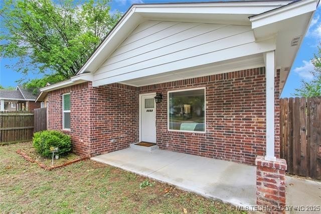 1332 N Denver Ave, Tulsa, OK 74106 - view of front of property featuring brick siding and a patio