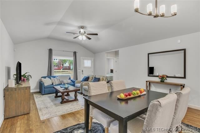 1332 N Denver Ave, Tulsa, OK 74106 - dining area featuring vaulted ceiling, wood finished floors, a chandelier, and a ceiling fan