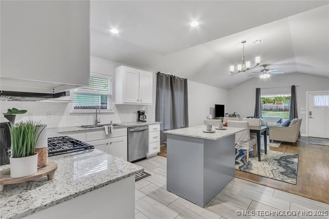1332 N Denver Ave, Tulsa, OK 74106 - kitchen featuring dishwasher, a ceiling fan, lofted ceiling, a kitchen island, and white cabinetry