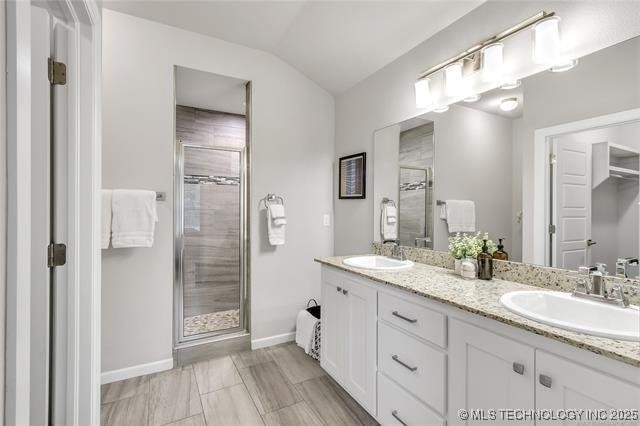 1332 N Denver Ave, Tulsa, OK 74106 - bathroom with a shower stall, double vanity, and lofted ceiling