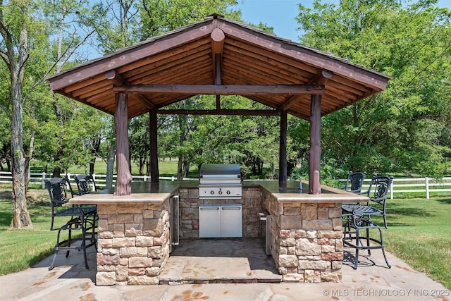 72878 S 230th Rd, Wagoner, OK 74467 - view of patio featuring an outdoor kitchen, a gazebo, and view of wooded area