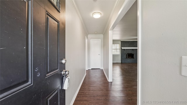2974 E 77th Pl, Tulsa, OK 74136 - entrance foyer with dark wood-style flooring and a brick fireplace