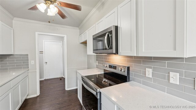 2974 E 77th Pl, Tulsa, OK 74136 - kitchen featuring appliances with stainless steel finishes, crown molding, white cabinets, tasteful backsplash, and a ceiling fan