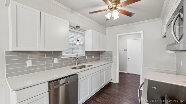 2974 E 77th Pl, Tulsa, OK 74136 - kitchen with appliances with stainless steel finishes, a ceiling fan, dark wood-style flooring, white cabinetry, and backsplash