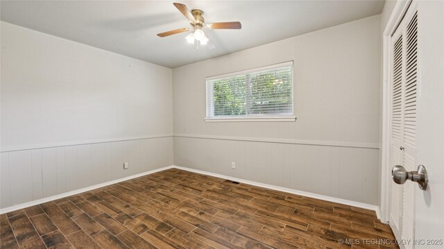 2974 E 77th Pl, Tulsa, OK 74136 - empty room featuring wood finished floors, a wainscoted wall, and a ceiling fan