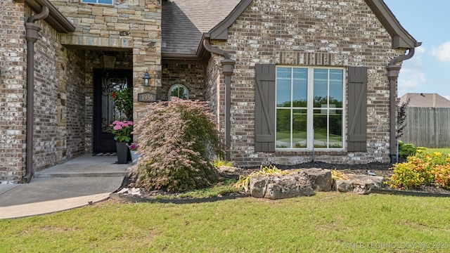 1956 E 172nd St S, Mounds, OK 74047 - entrance to property with stone siding, brick siding, and roof with shingles
