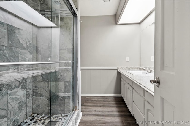 13050 S 143rd Ave E, Broken Arrow, OK 74011 - full bathroom with vanity, wood finished floors, a stall shower, and a wainscoted wall