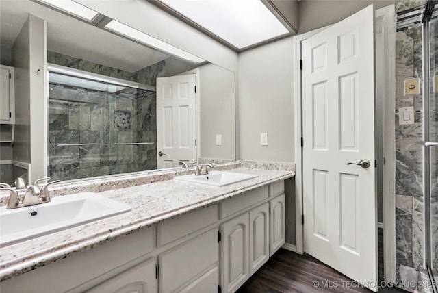 13050 S 143rd Ave E, Broken Arrow, OK 74011 - full bath with double vanity, a stall shower, and wood finished floors