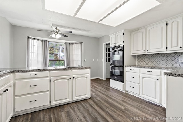 13050 S 143rd Ave E, Broken Arrow, OK 74011 - kitchen with a ceiling fan, decorative backsplash, dark wood-style floors, and white cabinets