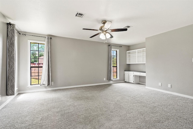13050 S 143rd Ave E, Broken Arrow, OK 74011 - unfurnished living room with carpet, a ceiling fan, and built in study area