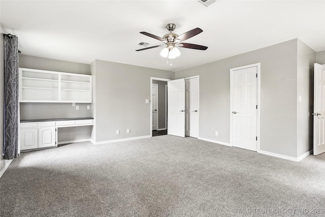13050 S 143rd Ave E, Broken Arrow, OK 74011 - unfurnished bedroom with carpet floors, built in study area, two closets, and a ceiling fan