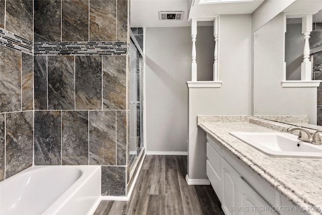 13050 S 143rd Ave E, Broken Arrow, OK 74011 - full bath featuring a shower with shower door, vanity, wood finished floors, and a tub to relax in