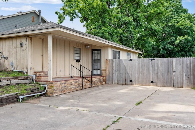 13050 S 143rd Ave E, Broken Arrow, OK 74011 - exterior space featuring a gate, board and batten siding, and a shingled roof