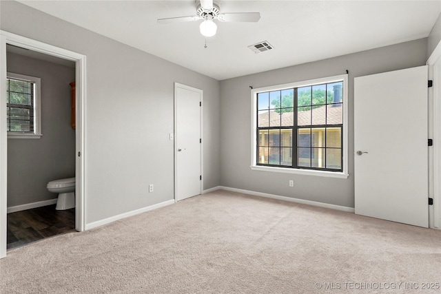 13050 S 143rd Ave E, Broken Arrow, OK 74011 - unfurnished bedroom featuring light carpet, ensuite bath, and ceiling fan