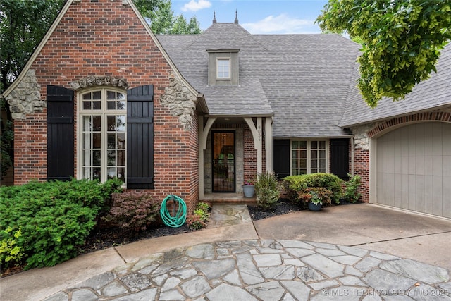 9034 S Maplewood Ave, Tulsa, OK 74137 - view of front of house featuring brick siding, concrete driveway, a shingled roof, and an attached garage