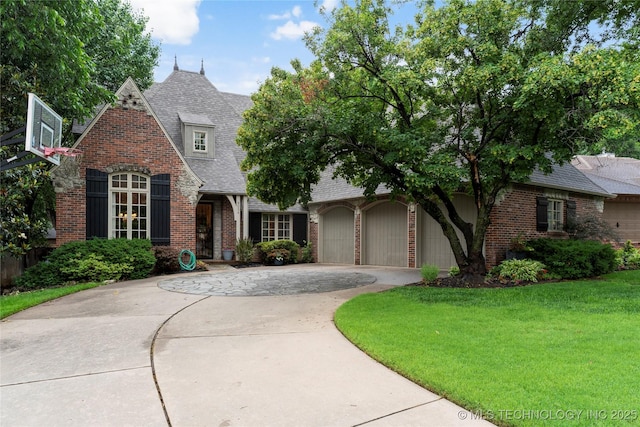 9034 S Maplewood Ave, Tulsa, OK 74137 - view of front of property with driveway, brick siding, a front yard, a shingled roof, and a garage