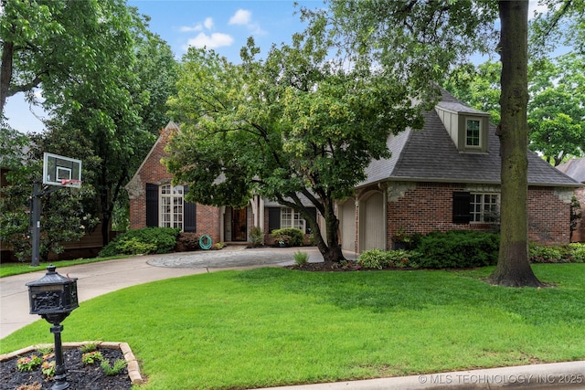 9034 S Maplewood Ave, Tulsa, OK 74137 - view of front of home featuring brick siding, a front lawn, curved driveway, and a shingled roof
